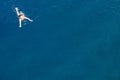 Aerial top view happy young woman in black swimsuit swims in the Red Sea, Egypt, Sharm el Sheikh. Vacation and adventure Royalty Free Stock Photo