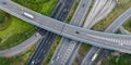 Aerial top view of highway junction interchange road. Drone view of the elevated road, traffic junctions, and green garden. Royalty Free Stock Photo