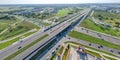 Aerial top view of highway junction interchange road. Drone view of the elevated road, traffic junctions, and green garden. Royalty Free Stock Photo