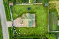 Aerial top view of house shingle roof and a car on paved yard with green grass lawn Royalty Free Stock Photo