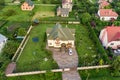 Aerial top view of house shingle roof and a car on paved yard with green grass lawn Royalty Free Stock Photo