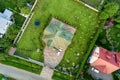 Aerial top view of house shingle roof and a car on paved yard with green grass lawn Royalty Free Stock Photo