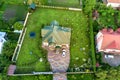 Aerial top view of house shingle roof and a car on paved yard with green grass lawn Royalty Free Stock Photo