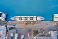 Aerial top view huge cargo ship moored at the pier at the port, loading goods, containers cargo Royalty Free Stock Photo