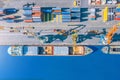 Aerial top view huge cargo ship moored at the pier at the port, loading goods, metal, concrete and other solid raw materials Royalty Free Stock Photo