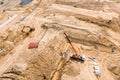 Industrial machinery laying concrete pipes for road drainage system. aerial view