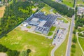 Aerial Top View of Industrial Storage Building Area with Solar Panels on the Roof and Many Trucks Unloading Merchandise Royalty Free Stock Photo