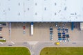 Aerial Top View of Industrial Storage Building Area with Solar Panels on the Roof and Many Trucks Unloading Merchandise Royalty Free Stock Photo