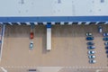 Aerial Top View of Industrial Storage Building Area with Solar Panels on the Roof and Many Trucks Unloading Merchandise Royalty Free Stock Photo