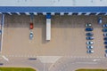 Aerial Top View of Industrial Storage Building Area with Solar Panels on the Roof and Many Trucks Unloading Merchandise Royalty Free Stock Photo