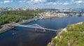 Aerial top view of Kiev city from above, Kyiv skyline, hills, pedestrian Park bridge and Dnieper river cityscape in spring