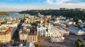 Aerial top view of Kyiv cityscape, Dnieper river and Podol historical district skyline, Kontraktova square with ferris wheel