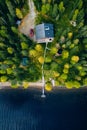 Aerial top view of log cabin or cottage with red car in spring forest in rural Finland Royalty Free Stock Photo