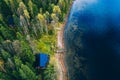 Aerial top view of log cabin or cottage with sauna in spring forest by the lake in Finland Royalty Free Stock Photo