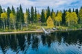 Aerial top view of log cabin or cottage with sauna in spring forest by the lake in Finland Royalty Free Stock Photo