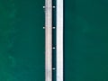 Aerial top view of a long highway bridge above a ocean. Royalty Free Stock Photo