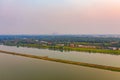 Aerial top view of lush green trees and river or lake from above in tropical forest in national park and mountain or hill in Royalty Free Stock Photo