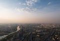 Aerial top view of Moscow city panorama at sunset, river and bridges, roads and buildings in evening myst