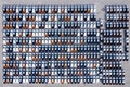 Aerial top view new cars lined up in the port for import export business logistic and transportation by ship in the open sea. New Royalty Free Stock Photo