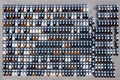 Aerial top view new cars lined up in the port for import export business logistic and transportation by ship in the open sea. New