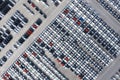 Aerial top view new cars lined up in the port for import export business logistic and transportation by ship in the open sea. New Royalty Free Stock Photo