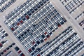 Aerial top view new cars lined up in the port for import export business logistic and transportation by ship in the open sea. New Royalty Free Stock Photo
