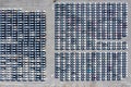 Aerial top view new cars lined up in the port for import export business logistic and transportation by ship in the open sea. New Royalty Free Stock Photo