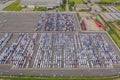 Aerial top view of new cars parking for sale stock lot row, dealer inventory import and export business commercial worldwide, Royalty Free Stock Photo