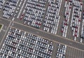 Aerial top view of new cars parking for sale stock lot row, dealer inventory import and export business commercial worldwide, Royalty Free Stock Photo