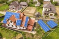 Aerial top view of new modern residential house cottage with blue shiny solar photo voltaic panels system on roof. Renewable Royalty Free Stock Photo