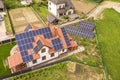 Aerial top view of new modern residential house cottage with blue shiny solar photo voltaic panels system on roof. Renewable Royalty Free Stock Photo