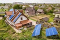 Aerial top view of new modern residential house cottage with blue shiny solar photo voltaic panels system on roof. Renewable Royalty Free Stock Photo