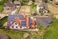 Aerial top view of new modern residential house cottage with blue shiny solar photo voltaic panels system on roof. Renewable Royalty Free Stock Photo