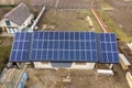 Aerial top view of new modern residential house cottage with blue shiny solar photo voltaic panels system on roof. Renewable Royalty Free Stock Photo