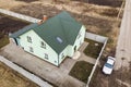 Aerial top view of new residential house cottage with brick chimney and attic window in shingle roof on fenced big property on Royalty Free Stock Photo