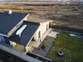 Aerial top view of new residential house cottage and terrace with shingle roof on fenced big yard on sunny winter day Royalty Free Stock Photo