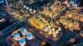 Aerial top view oil and gas tank with oil refinery background at night, Business petrochemical industrial, Refinery factory oil