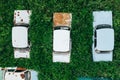 Aerial top view of old retro rusty abandoned cars in green grass, cemetery of vintage cars Royalty Free Stock Photo