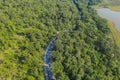 Aerial top view over mountain rural road in tropical rainforest with green tree Royalty Free Stock Photo