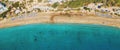 Aerial top view panorama of beautiful Coral beach in Paphos with azure seawater, Cyprus. Sand coast with umbrellas Royalty Free Stock Photo