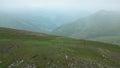 Aerial top view panorama solo caucasian woman hiker backpacker stand on viewpoint in caucasus mountains. Sakori lake hiking trail