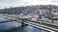 Aerial top view of pedestrian Park bridge in winter and Dnieper river from above, snow Kyiv cityscape, city of Kiev skyline Royalty Free Stock Photo