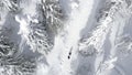 Aerial top view of people hiking on winters trail. Clip. Rural road covered by snow, landscape of winter nature. Royalty Free Stock Photo