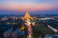 Aerial top view of Phra Pathommachedi temple at night. The golden buddhist pagoda with residential houses, urban city of Nakorn