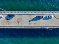 Aerial top view of pier with parked car in the ocean Royalty Free Stock Photo