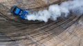 Aerial top view professional driver drifting car on asphalt road track with white smoke, Automobile race car drift on abstract Royalty Free Stock Photo