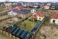 Aerial top view of residential area with new houses with roof solar photo voltaic panels, wind turbine mill and stand-alone Royalty Free Stock Photo