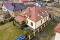 Aerial top view of residential area with new houses with roof solar photo voltaic panels, wind turbine mill and stand-alone Royalty Free Stock Photo