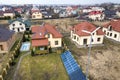 Aerial top view of residential area with new houses with roof solar photo voltaic panels, wind turbine mill and stand-alone Royalty Free Stock Photo