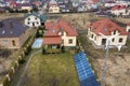 Aerial top view of residential area with new houses with roof solar photo voltaic panels, wind turbine mill and stand-alone Royalty Free Stock Photo